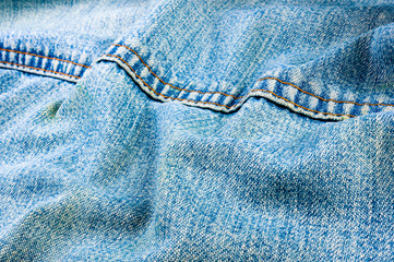 clothing items blue stonewashed faded jeans cotton fabric texture with seams, clasps, buttons and...