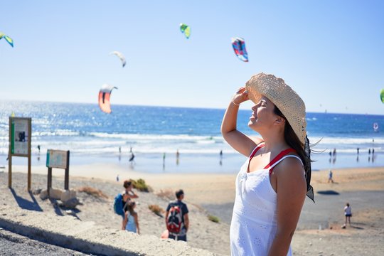 Young beautiful woman smiling happy enjoying summer vacation at the medano beach in Gran Canaria