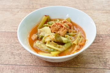 boiled mixed vegetable and fish egg in Thai spicy soup on bowl