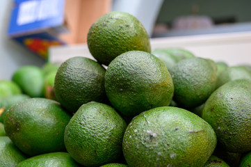 Fresh ripe green avocados in box on farmers market in Spain