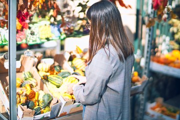 Young beautiful woman smiling happy and confident. Standing with smile on face at florist