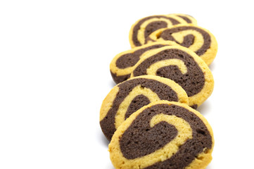 Cookies in the shape of a spiral pattern isolated on a white background. Handmade biscuits. Copy space.