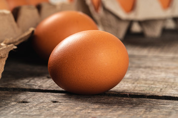 Chicken eggs in box on wooden table.