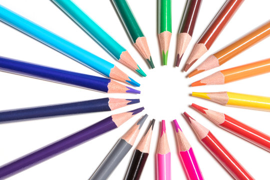 color pencils lie around on a white background