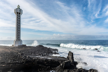 Fototapeta premium Dangerious ocean stormy waves hits black lava rocks by Faro de las Hoyas, La Palma island, Canary, Spain