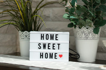  a white illuminated cinema sign with black letters Home sweet home