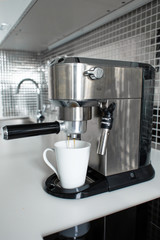 Close-up of making coffee in a coffee machine.