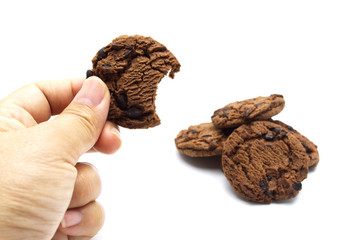 Hand holding cookie with Chocolate chip biscuit isolated on white background.