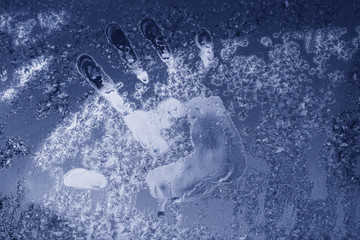 handprint on frozen glass close-up