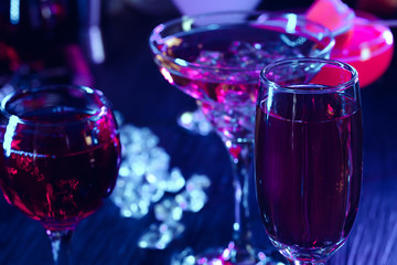 Cocktail drinks with ice in club lights