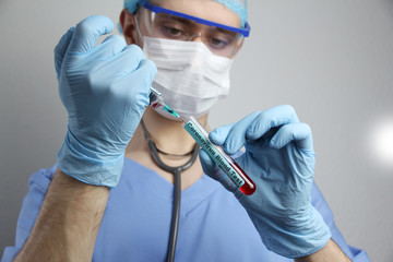 medical laboratory test tube and syringe with blood in the hand of a virologist doctor, concept of...