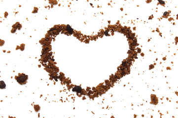 The shape of a heart line with crumbs from chocolate chip cookies isolated on white background in...