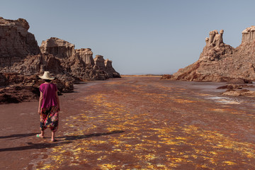 Unrecognized traveler looking at a desert canyon in danakil depression desert in Ethiopia