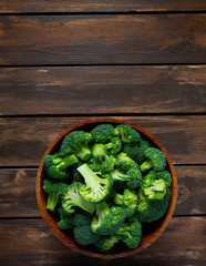 fresh broccoli on wooden surface