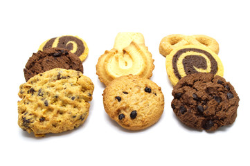 Stack of assorted cookies. Chocolate chip, oatmeal, raisin, Danish cookies and biscuits in the shape of a spiral pattern isolated on white background.