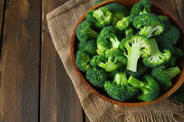 fresh broccoli on wooden surface