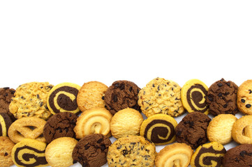 A group of assorted cookies. Chocolate chip, oatmeal, raisin, Danish cookies and biscuits in the shape of a spiral pattern isolated on white background and copy space.