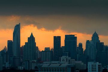 Fototapeta premium Silhouette of City skyline while sunset in downtown district at Bangkok.