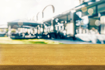 Closeup of wooden table top and blurred modern city cafe