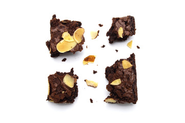 Chocolate brownie with sliced almond nuts toppings broken and crumbs isolated on white background.