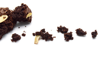 Crumble of chocolate brownies with sliced almond nuts toppings isolated on white background.