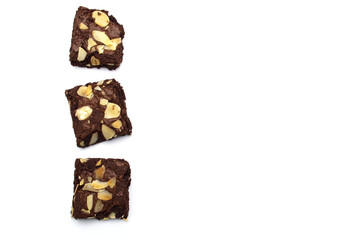 Chocolate brownies with sliced almond nuts toppings isolated on white background and copy space.