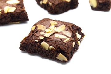 Chocolate brownies with sliced almond nuts toppings isolated on white background.