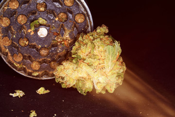Metal grinder with marijuana, isolated on a black 