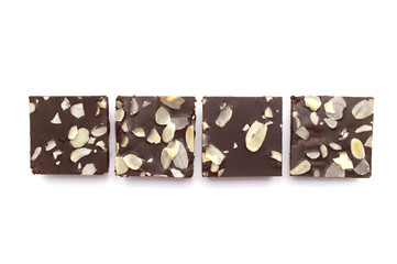 Chocolate brownies with sliced almond nuts toppings isolated on white background.
