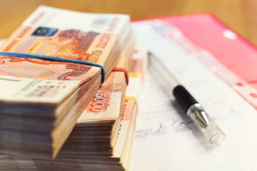 Money stacks - one and a half million russian rubles and signed contract