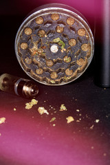 Metal grinder with marijuana, isolated on a black 