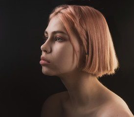 impulsive girl with light hair on a dark background, portrait of a girl with large facial features