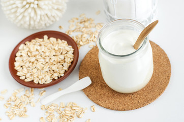Homemade greek yogurt and oatmeal face mask in the glass jar. Diy natural beauty treatment recipe. Copy space