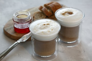 Breakfast. Coffee with milk, bun with butter and jam