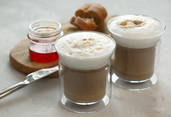 Breakfast. Coffee with milk, bun with butter and jam