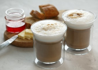 Breakfast. Coffee with milk, bun with butter and jam