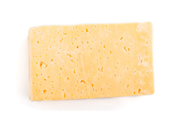 Piece of yellow cheese isolated on white background. Top view.