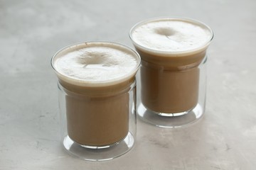 Two glass cups with latte coffee