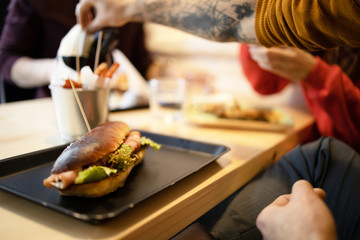 Obraz na płótnie Canvas Enjoying the tasty fast food in restaurant
