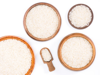 Indian long grain Basmati rice in wooden bowls and scoop on white. Indian cuisine, ayurveda, naturopathy concept