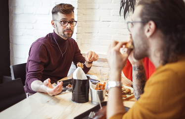 Young Friends Eating in Fast Food Restaurant