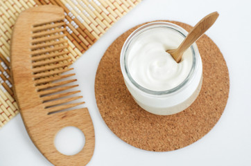 Homemade greek yogurt face and hair mask in the glass jar. Diy natural beauty treatment recipe. Top view, copy space.