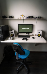 The workplace of a professional gamer with a monitor, gamepad, headphones and an armchair.