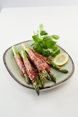 Fresh green spring asparagus spears with ham