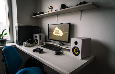 Cloud gaming: the workplace of a professional gamer with a monitor, gamepad, headphones and an...