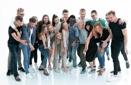 group of cheerful young people with looking at a copy of the space