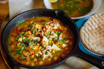 Shurpa with chicken and chickpeas in a pan. Israeli cuisine