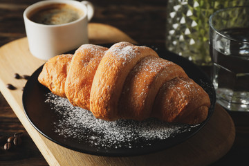 Composition with delicious croissant on wooden background, close up