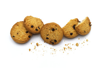 Chocolate chip cookies and crumble cracks on white background. Pile of sweet biscuits delicious and crunchy homemade pastry.
