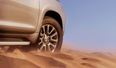 Fototapeta na wymiar Close up of a golden car stuck in the sand in the Namib desert. Walvis Bay. Namibia. Africa
